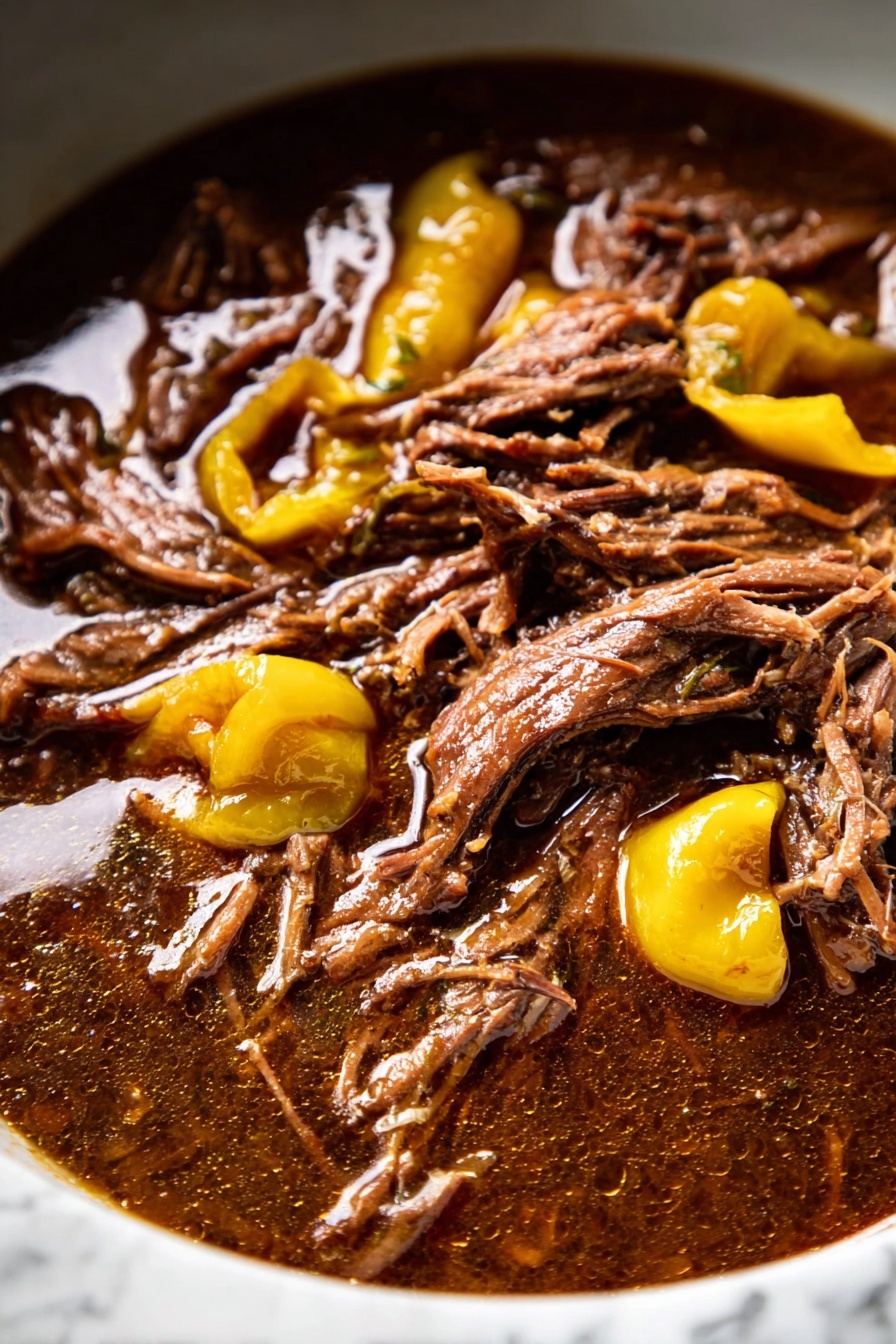 A white speckled bowl filled with three layers: the bottom layer is creamy mashed potatoes, smooth and pale white in color. On top of the mashed potatoes, there is a layer of shredded, dark brown meat with a tender texture. Scattered around the meat are several yellow-green peppers with a glossy surface. Above, a woman's hand holds a dark spoon pouring a thick, brown gravy covering parts of the meat and mashed potatoes. The background shows a white marbled surface with soft lighting that highlights the dish's rich colors and textures, photo taken with an iphone --ar 2:3 --v 7