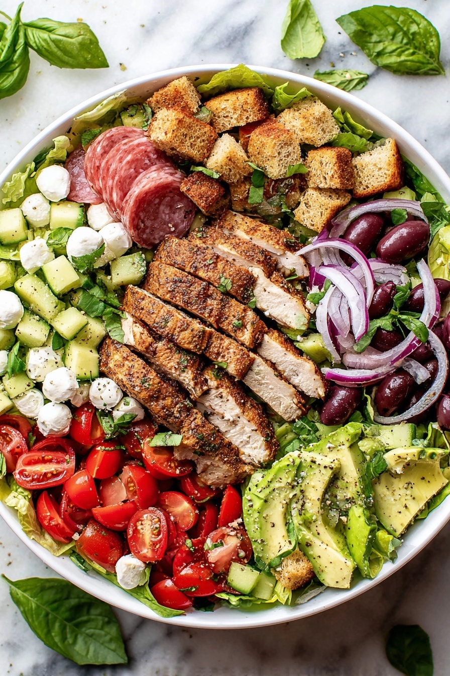 The image shows a large white bowl filled with a salad made of several layers. The base is bright green lettuce leaves spread evenly around the bowl. On top of the lettuce, there are neatly placed slices of grilled chicken with a brown, seasoned texture in the center. Around the chicken, there are chunks of green cucumber, halved red cherry tomatoes, light green avocado slices, sliced red onions, dark purple olives, and small white mozzarella balls. There are also several golden-brown croutons scattered over the salad. In one section, thin slices of pinkish salami are layered together. Fresh green basil leaves and parsley are sprinkled across the entire salad adding a fresh touch. The bowl sits on a white marbled surface with scattered basil leaves nearby. photo taken with an iphone --ar 2:3 --v 7