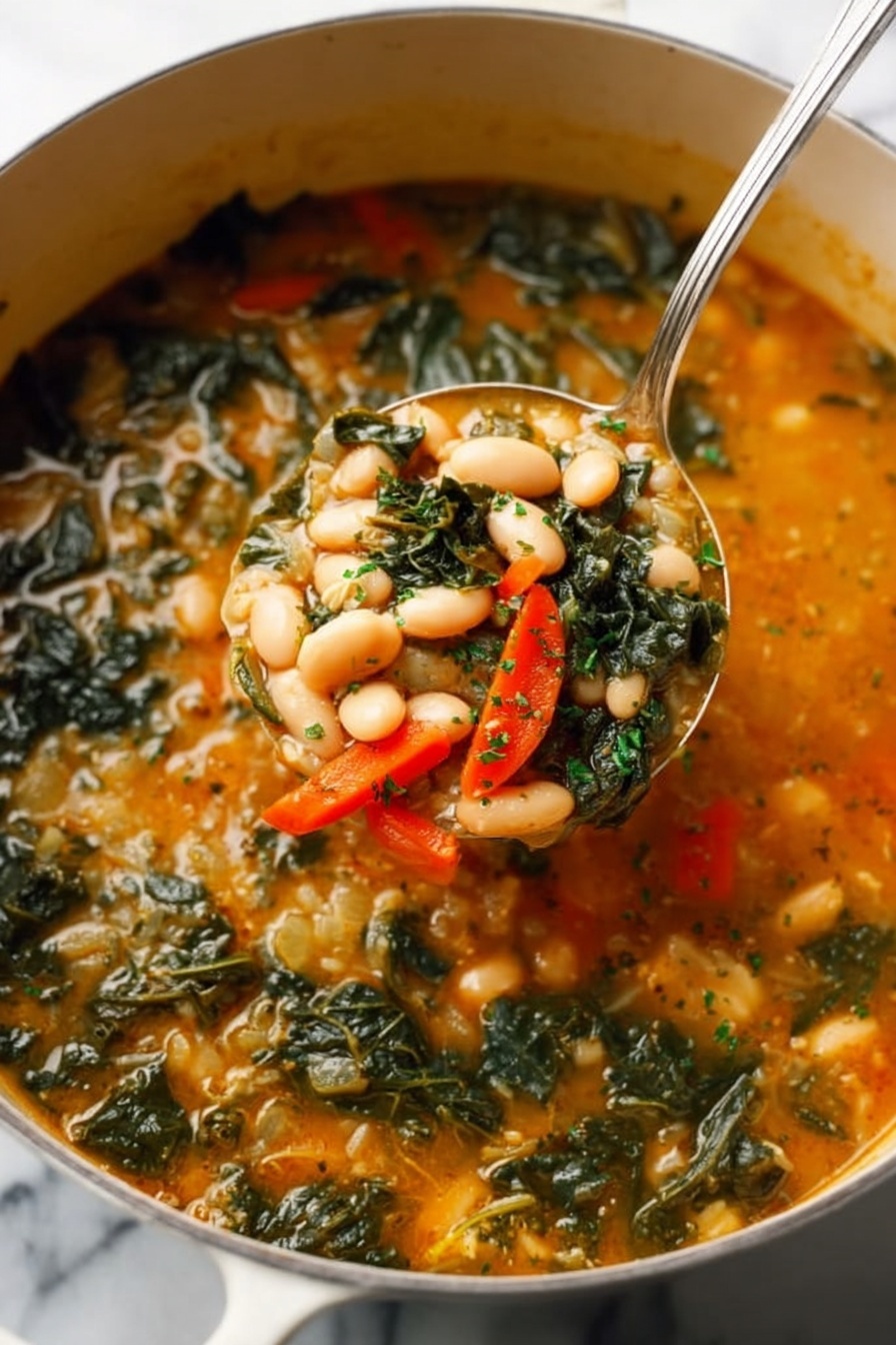 A close-up of a white pot filled with soup showing three main layers: the bottom layer is a thick orange broth with a slightly creamy texture; floating in this are many white beans, dark green leafy vegetables, and thin bright orange slices of carrots evenly mixed throughout; the top layer has small green herb bits sprinkled on the surface. A silver spoon lifts a scoop of the soup, clearly showing the beans, greens, and carrot slices together. The pot sits on a white marbled surface. photo taken with an iphone --ar 2:3 --v 7