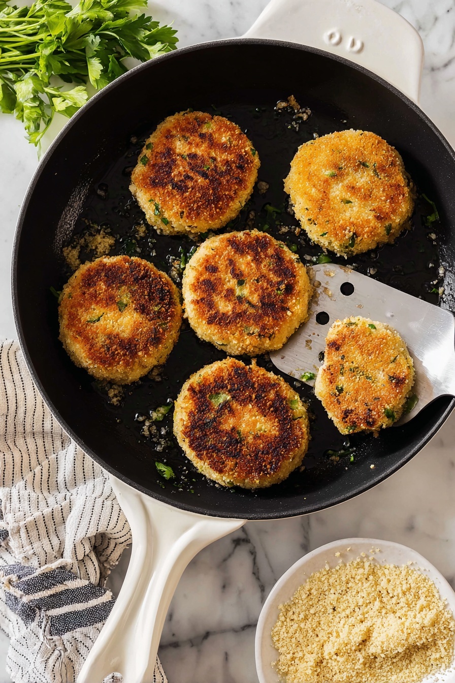 The image shows a white round plate with seven golden-brown crispy patties, each topped with small pieces of green onion scattered evenly. Next to the patties, on the same plate, there is a small black bowl filled with a smooth white sauce. In the background, there is another white round plate with two of the patties, one partially taken by a woman's hand holding it, showing a soft, light inside. Beside it are two stacked white plates with a fork and spoon on top. The surface beneath everything is white marbled texture. A striped napkin is placed near the plates. Photo taken with an iphone --ar 2:3 --v 7
