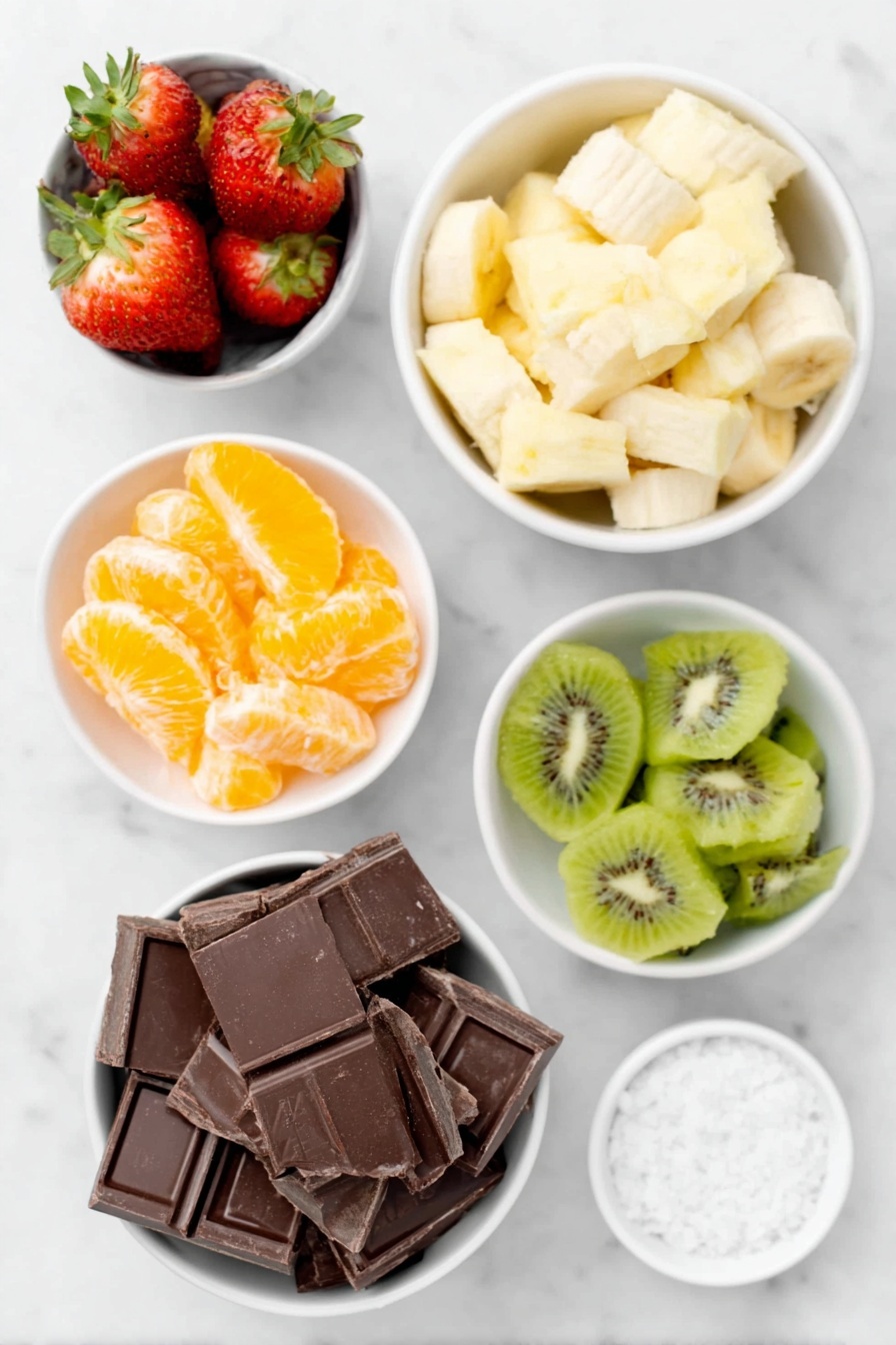Flat lay of fresh hulled strawberries, peeled orange segments cut in halves, bright pineapple chunks, sliced banana pieces, peeled kiwi chunks, broken pieces of smooth dark chocolate in a small white ceramic bowl, and a small white bowl of flaky sea salt, all arranged symmetrically on simple white ceramic dishes, placed on a clean white marble surface, soft natural light, photo taken with an iPhone, professional food photography style, fresh ingredients, white ceramic bowls, no bottles, no duplicates, no utensils, no packaging --ar 2:3 --v 7 --p m7354615311229779997